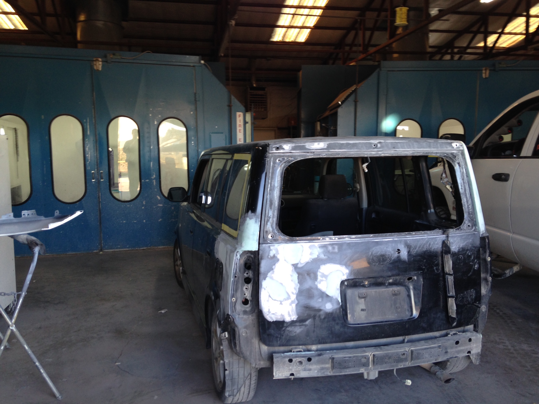 A vehicle body stripped down for collision repair inside Campbell's Auto Body's shop in Stephenville, TX